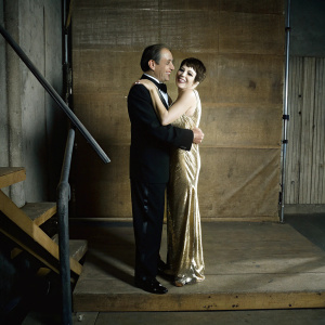 Liza Minnelli and her father Vincente Minnelli at a gala event. They are both dressed formally and sharing a warm embrace.