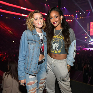 Miley Cyrus and Rihanna at a bustling concert venue. Wearing casual streetwear.