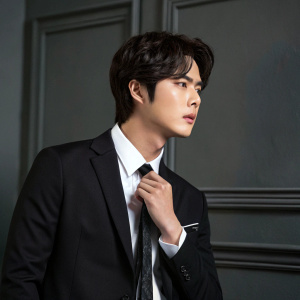 Jumin Han from the popular Korean drama Mystic Messenger. Black suit and white shirt. Adjusting tie. Dark gray background.