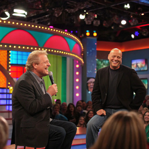 Jerry Springer and Steve Wilkos hosting a radio show segment. Studio audience visible, colorful stage setup