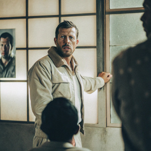 Bob Lee Swagger, ex-Marine, intense stare. Serious, focused pose. Surrounded by thumbnails of other characters
