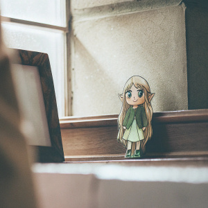 A cute chibi alien character, long blonde hair, surprised face, green outfit with purple background