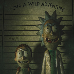 Rick and Morty cartoon characters, exaggerated facial expressions, on a police mugshot template. Backdrop is a stark white with bold text saying 'On a wild adventure'