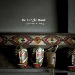 DVD cover of 'The Jungle Book' by Rudyard Kipling. Bright colors, intricate patterns, and various animal faces. Traditional tribal art inspired design. French text overlaying the animal faces.