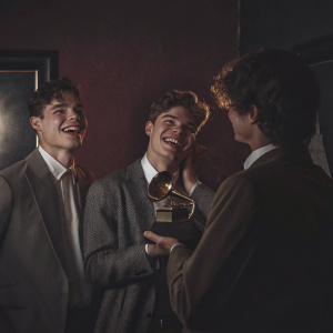 Forever In Your Mind band members Liam Attridge, Ricky Garcia, and Emery Kelly celebrating at the Grammy Awards ceremony.