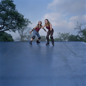 Jennifer Garner and Kirsten Prout in a park scene from 'Elektra'. Dynamic, candid pose against natural backdrop.