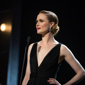 Evan Rachel Wood at New York Film Awards. Black dress, elegant makeup. Dark stage with spotlight