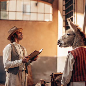 HEAD: A NORMAL PERSON WITH A DONKEY HEAD AND STANDING IN HIS POSTURE. THE NORMAL PERSON IS TELLING AN EVENT TO THE PERSON WITH A DONKEY HEAD.